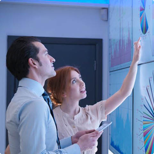 coworkers presenting a whiteboard of data