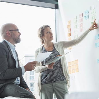 coworkers using a whiteboard