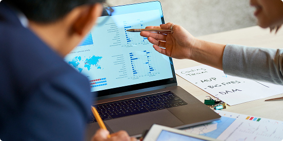 coworkers looking at a laptop
